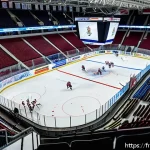 벨라루스에서 유명한 스포츠 - A vibrant ice hockey game scene inside the Minsk Arena, showcasing a packed crowd of enthusiastic Be...